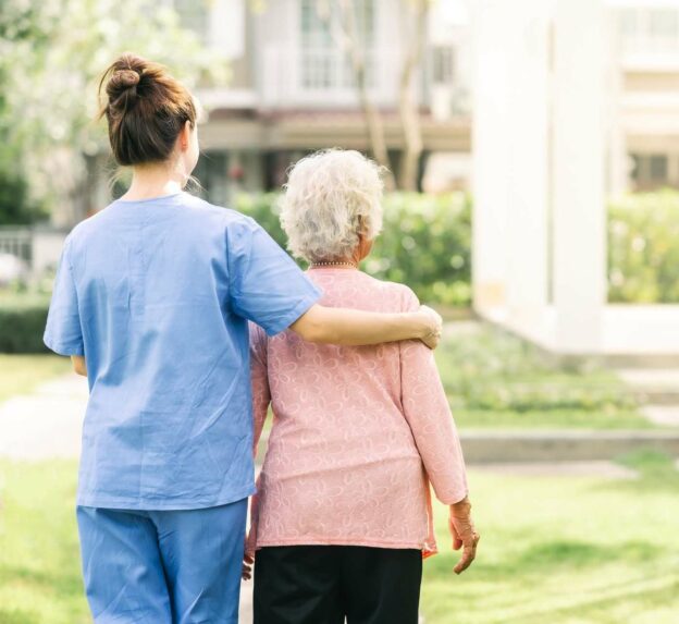 A nurse holding an old person