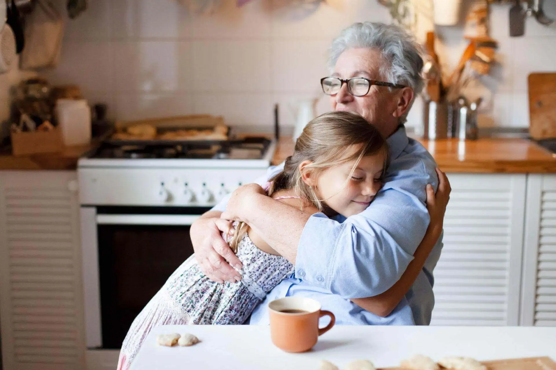 A grandmother hugging her granddaughter