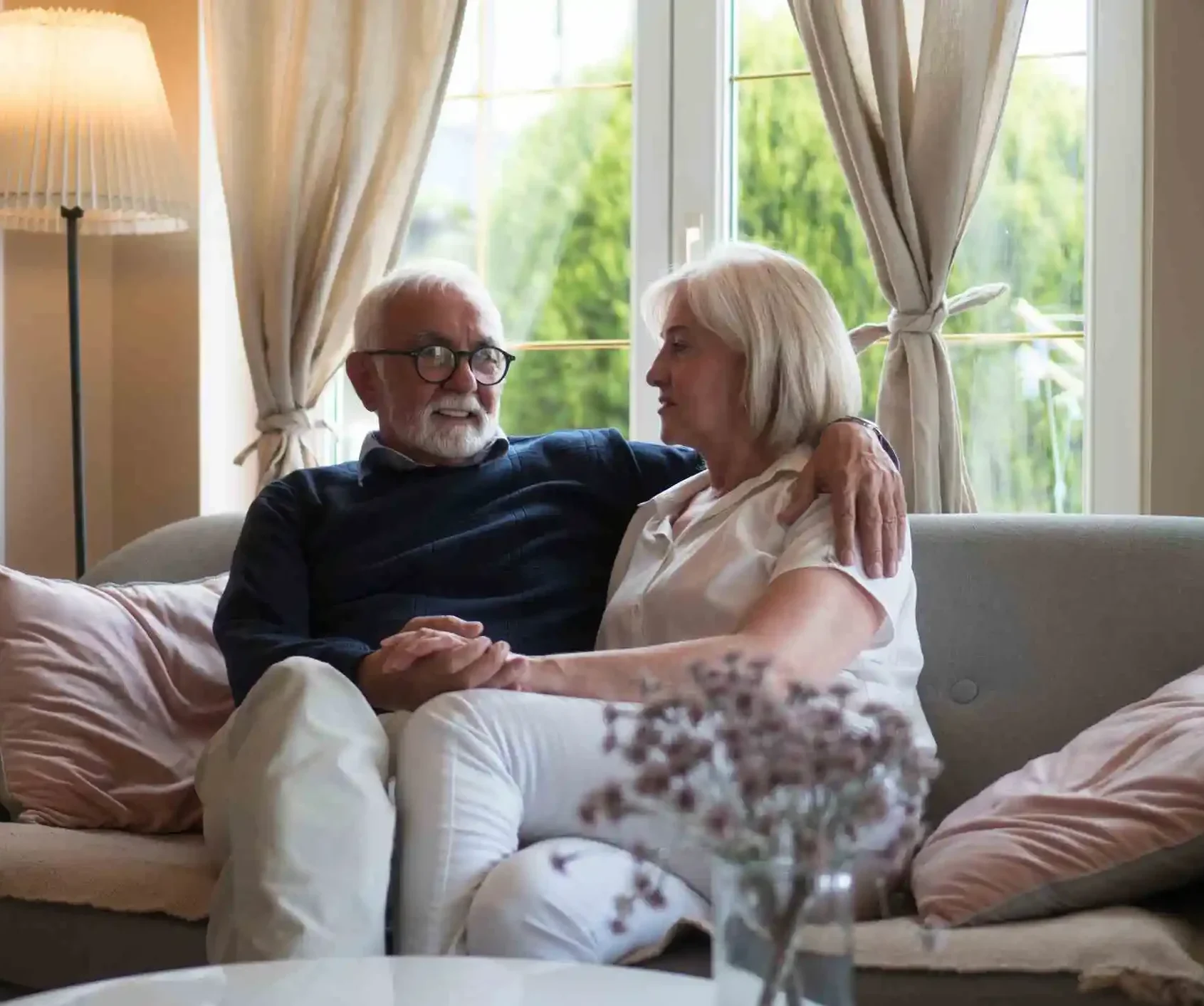 Elderly couple sitting together at home