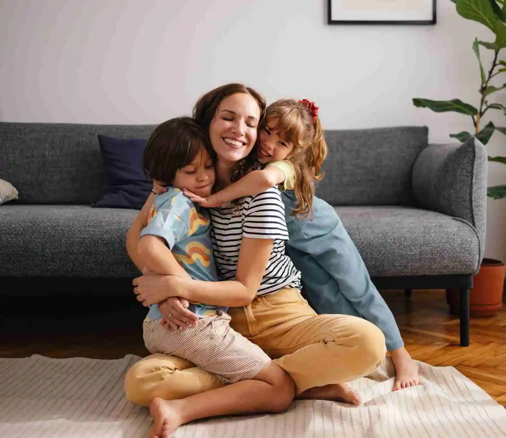 Smiling woman with 2 toddlers