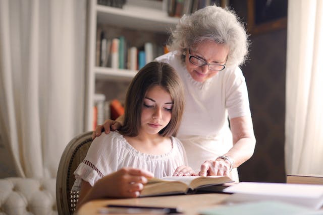 grandmother reading with her granddaughter