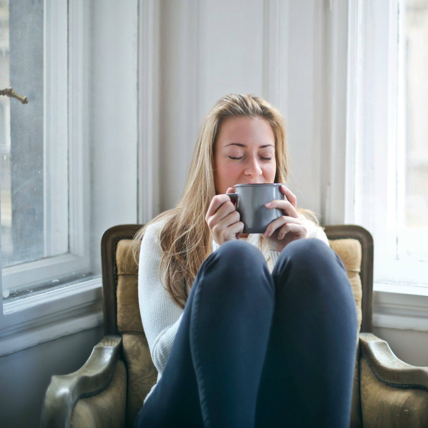 woman sat down drinking coffee