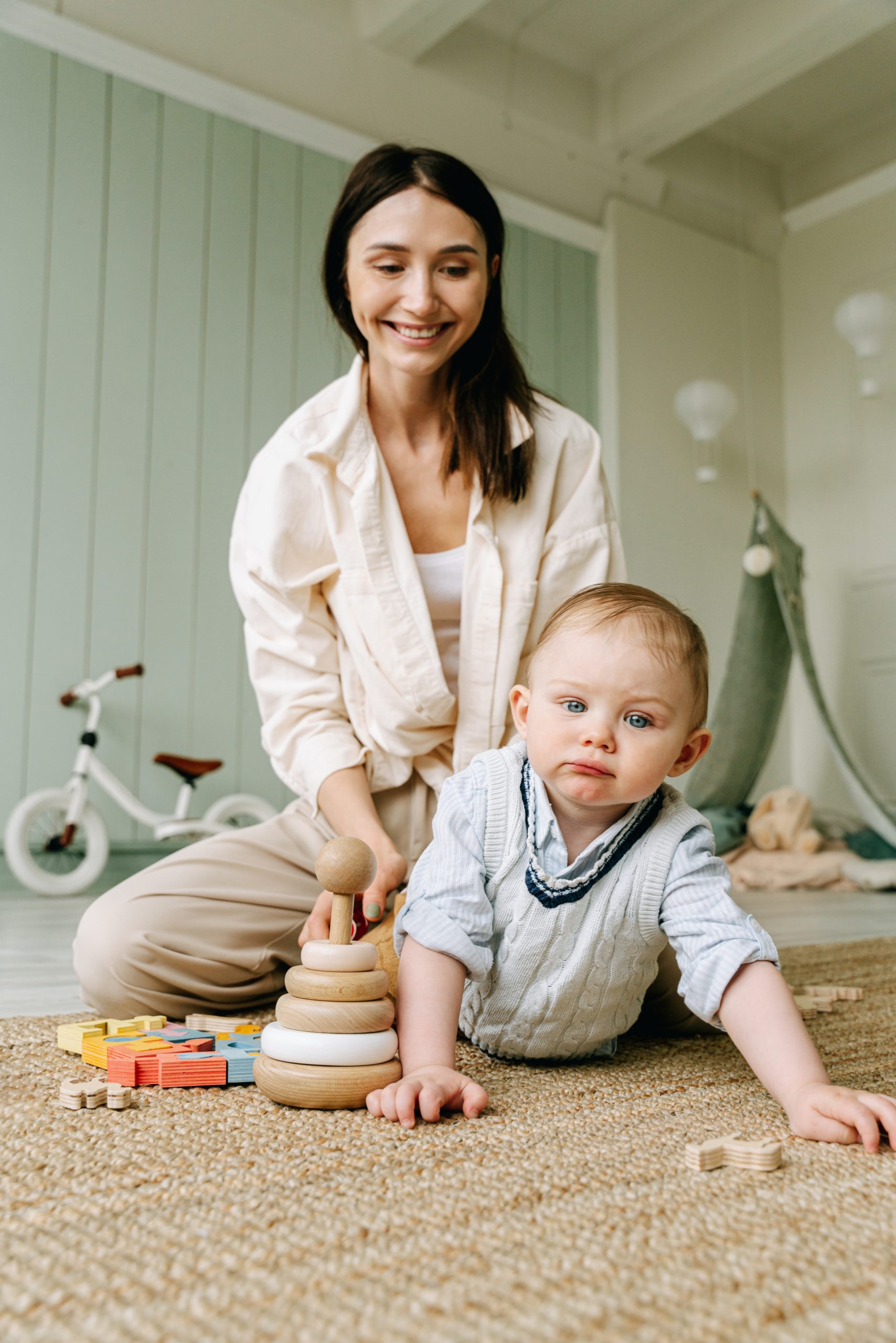 A person and a baby playing with toys