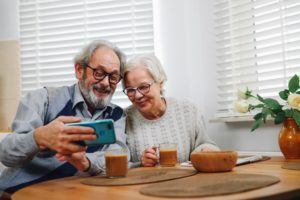 Senior people looking at a phone
