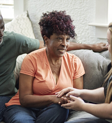 caregiver speaking to her patient and husband