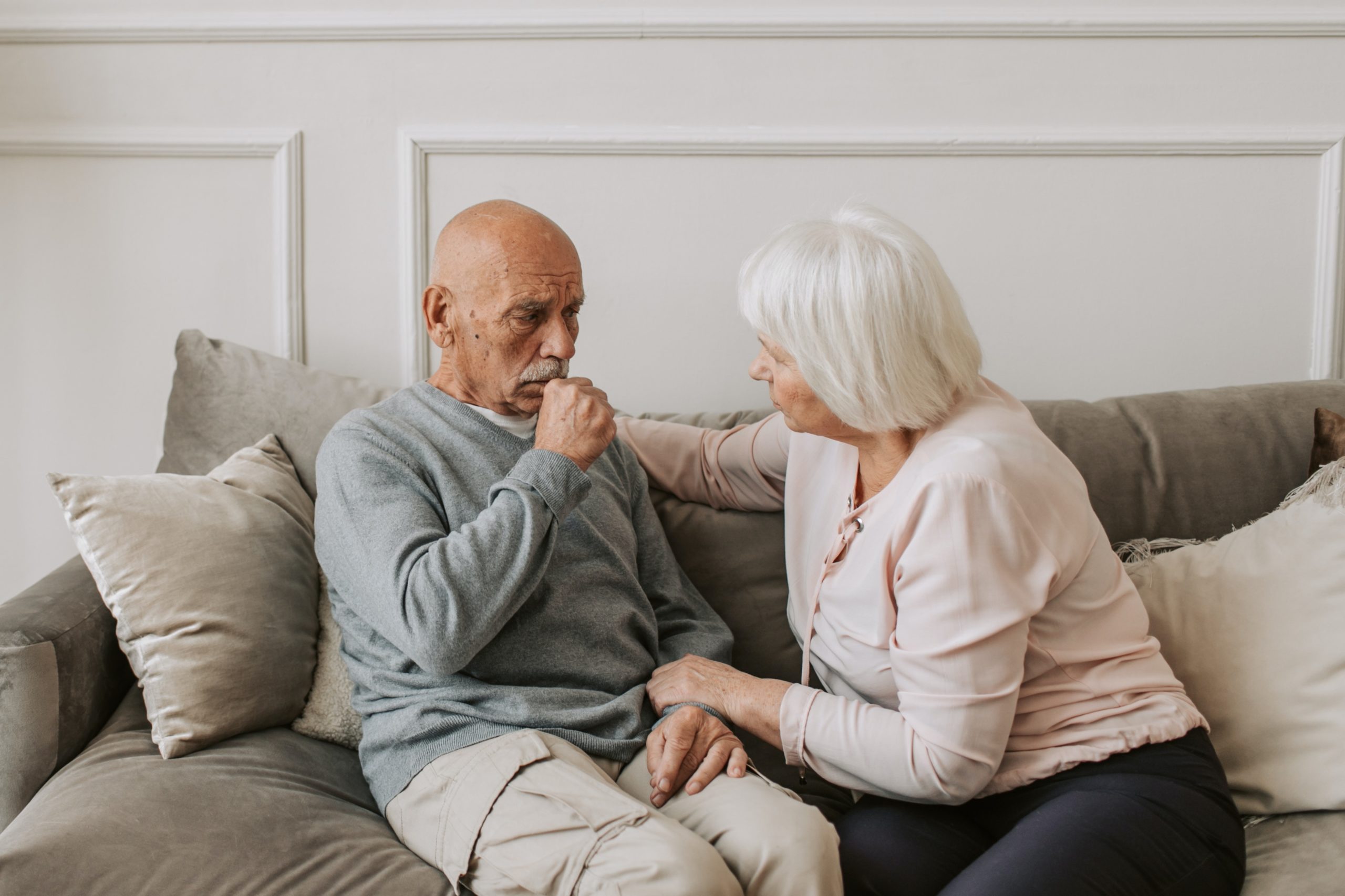 A person and person sitting on a couch