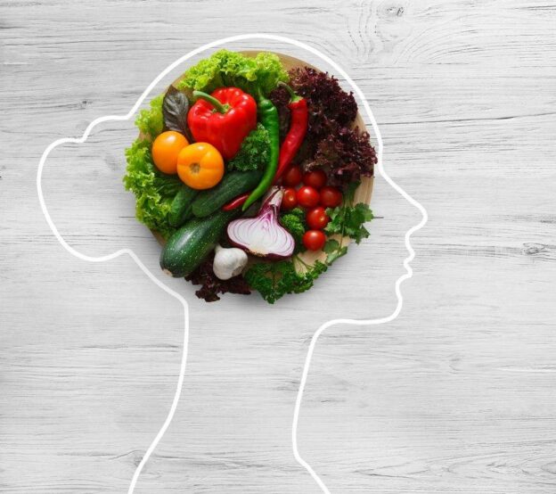 A person's head with vegetables in it