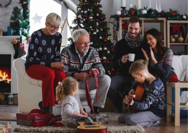 A group of people sitting in a living room during Christmas