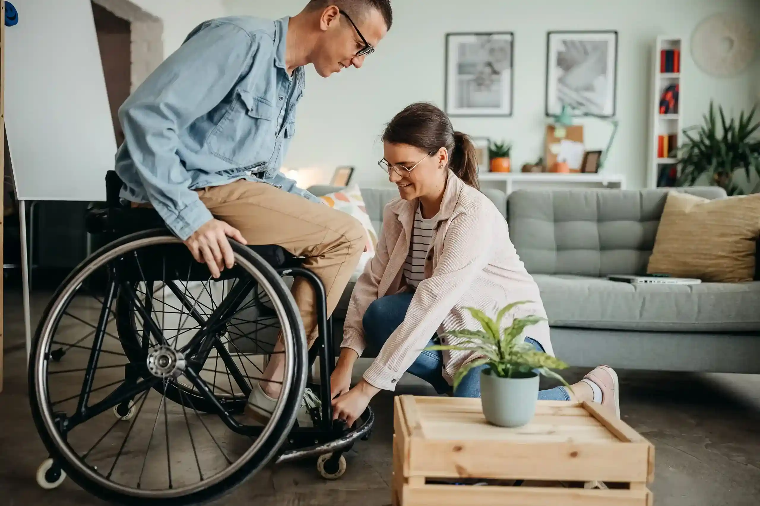 Lady helping a man in a wheelchair