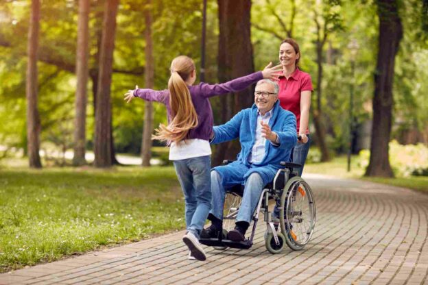 A person in a wheelchair with a child in the park
