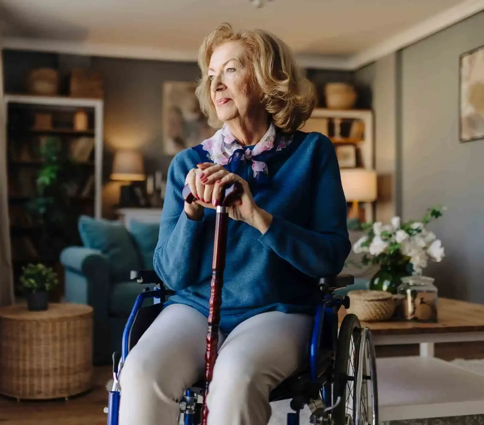 Portrait of senior woman in wheelchair resting hands on walking stick