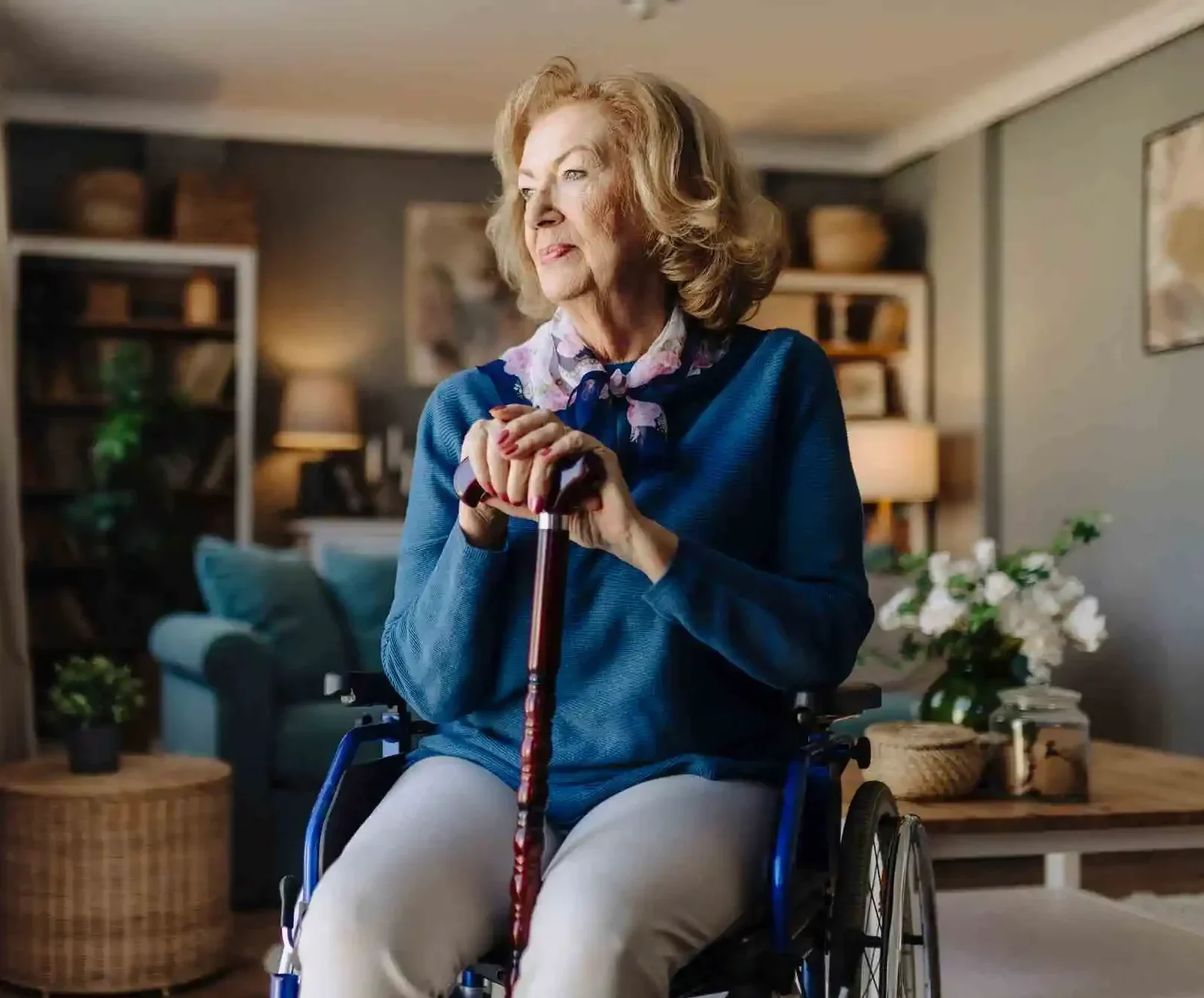 Portrait of senior woman in wheelchair resting hands on walking stick