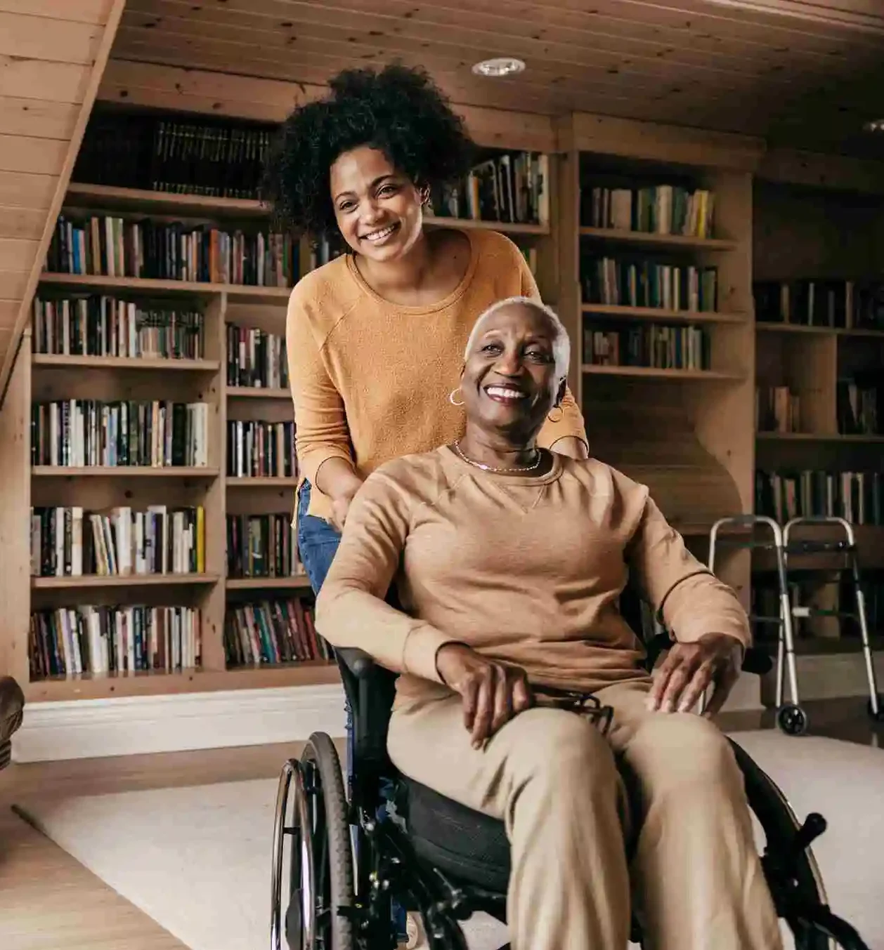 Carer supporting woman in wheelchair