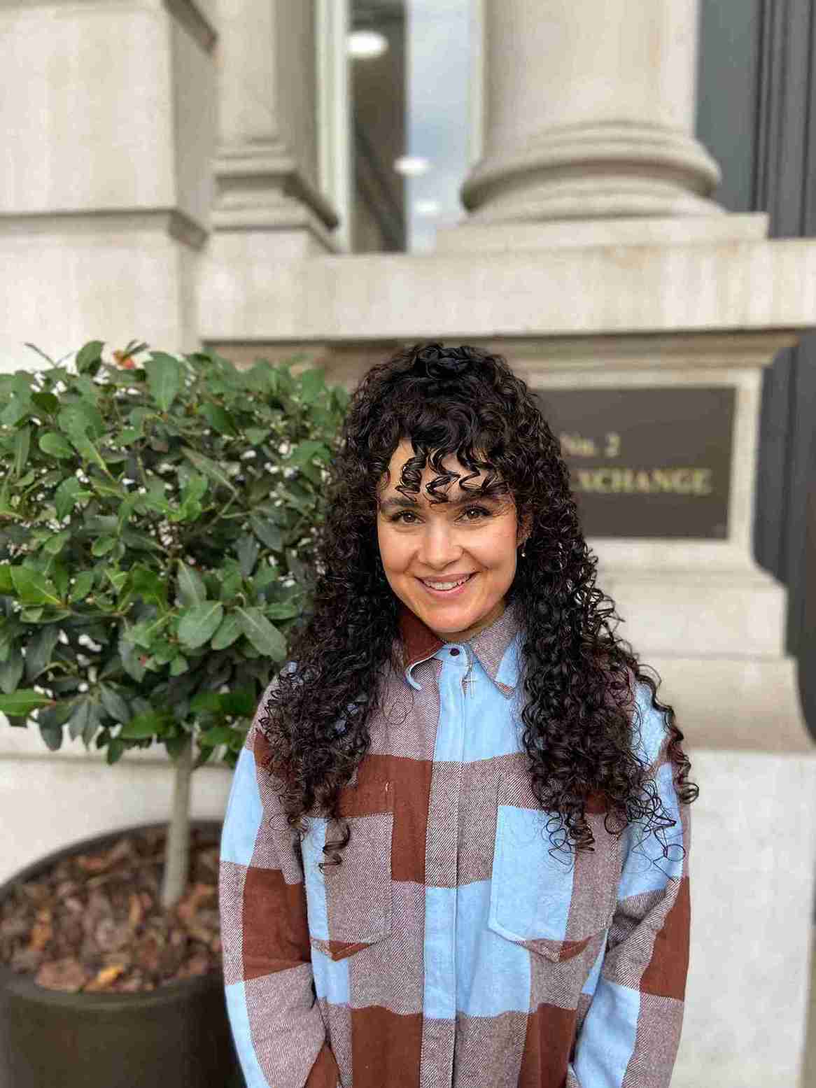 Woman with curly hair smiling