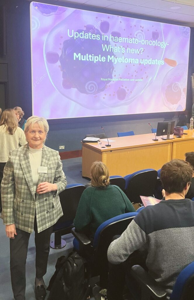 Woman standing in front of a screen in an auditorium