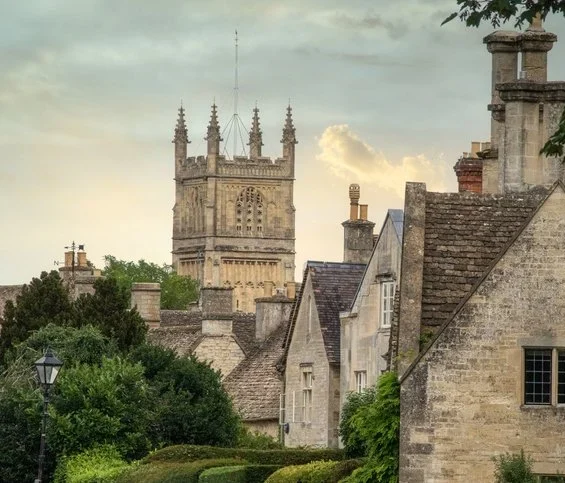 Cirencester tower with stone houses in foreground