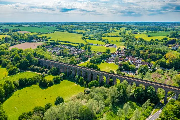 Countryside scene with railway bridge and 2 small villages