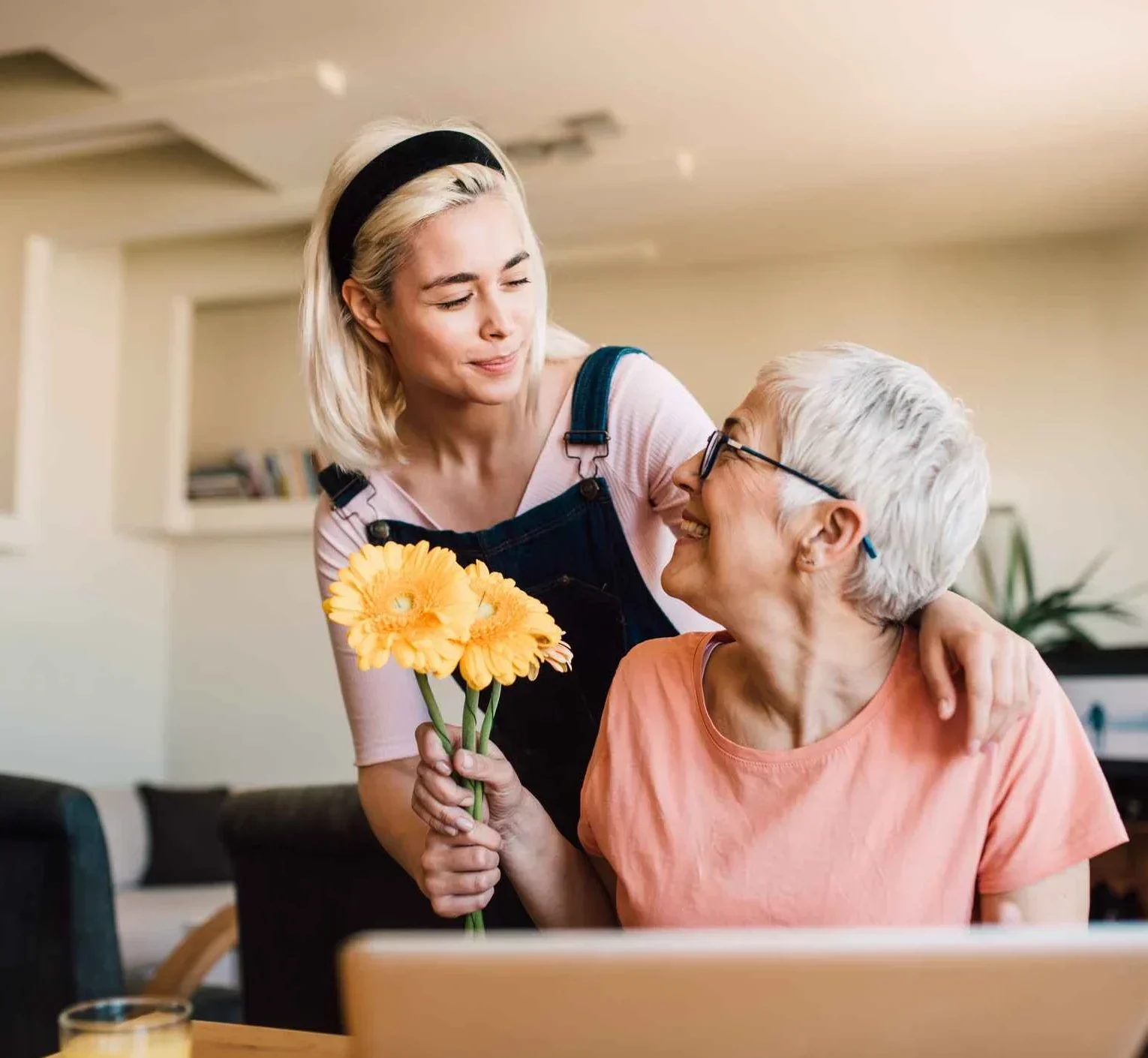 Smiling mouth and daughter in kitchen passing a flower