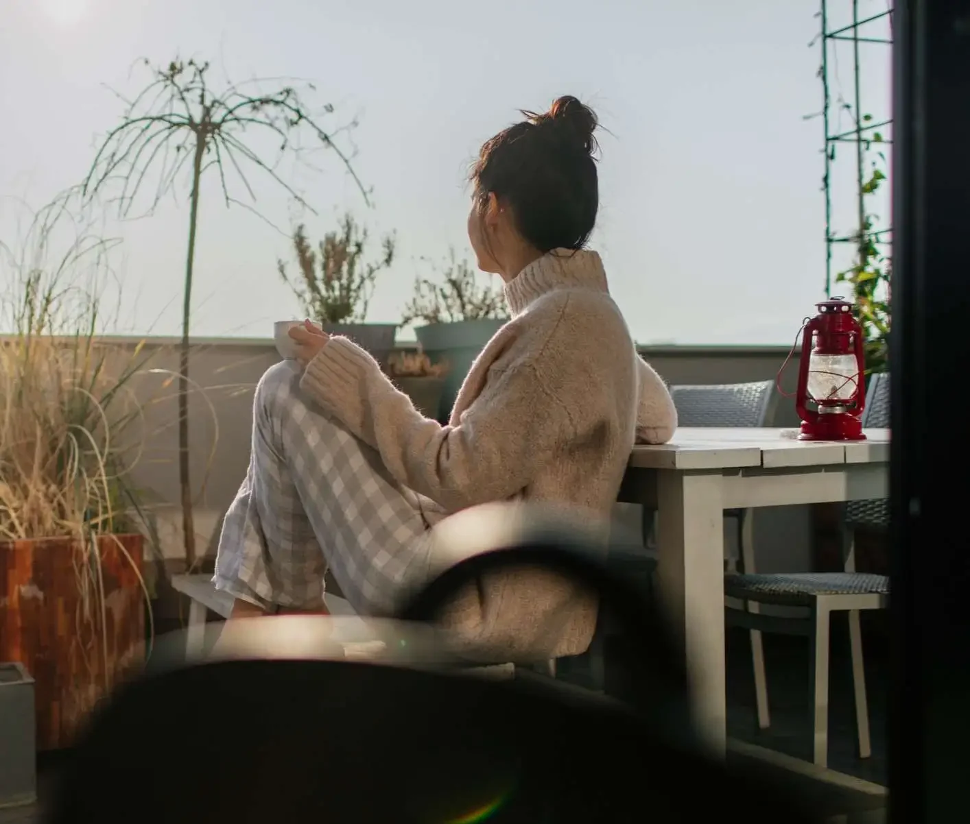 Woman relaxing drinking tea on a balcony