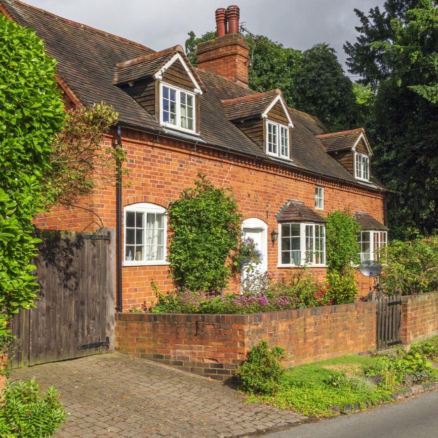 A leafy red brick house in the British Countryside