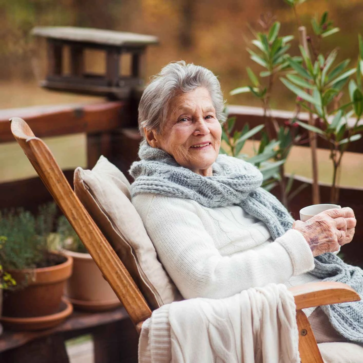 Smiling old lady drinking tea