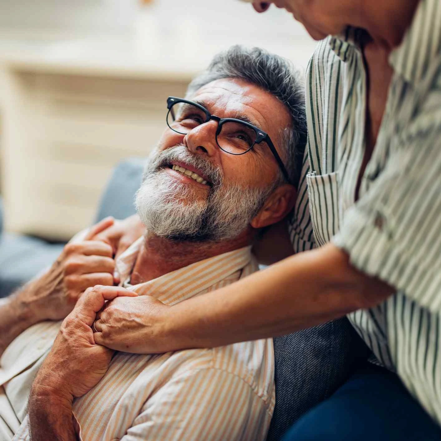Smiling man in womans arms